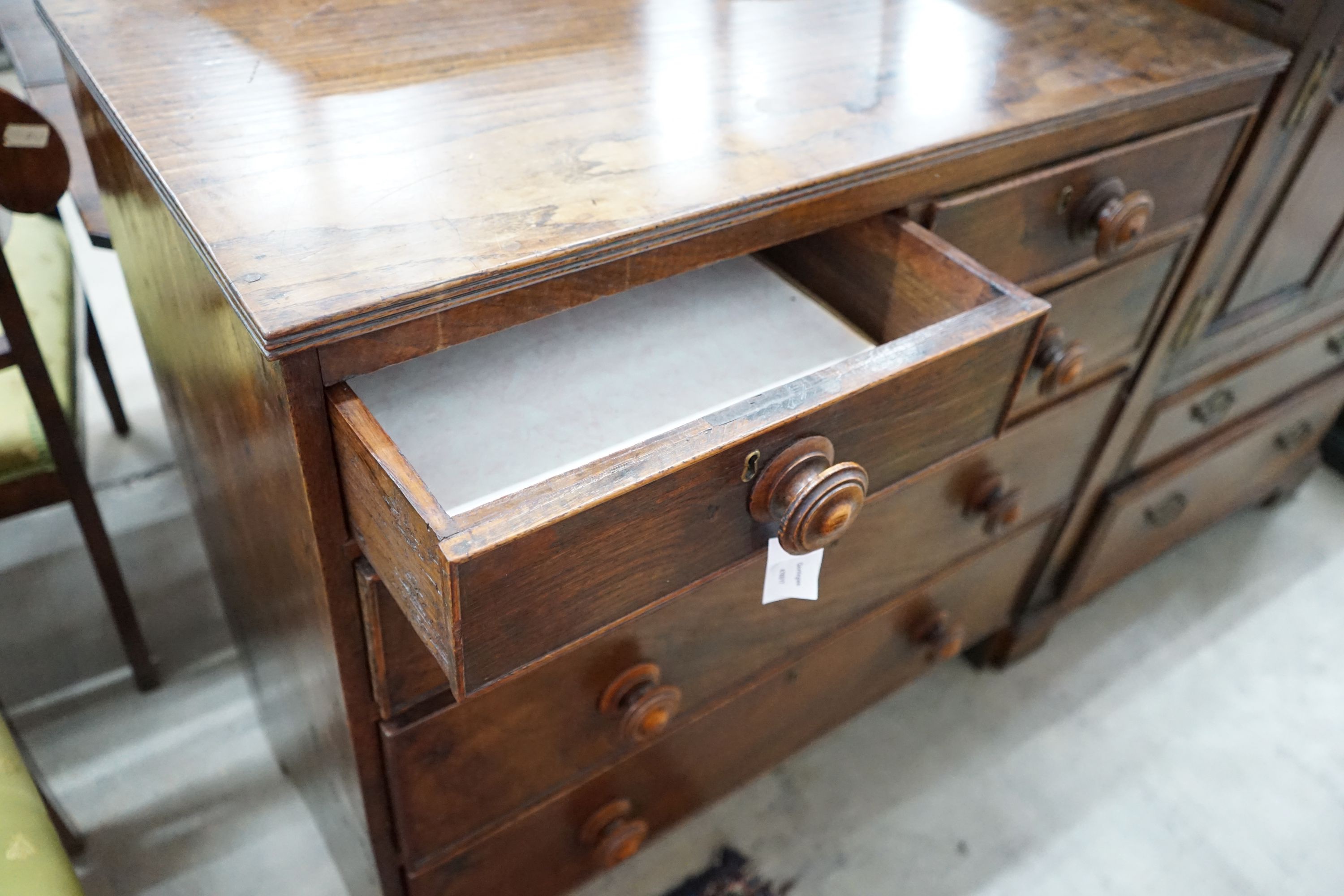 An early 19th century provinical oak chest of two short and three long drawers, width 93cm, depth 48cm, height 94cm